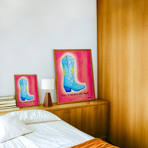 Fort Worth Boot Pink cowboy boot art print by Caya Crum — framed in a wood-accent room