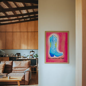Fort Worth Boot Pink cowboy boot art print by Caya Crum — framed in a wood-accent room
