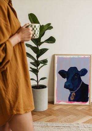 Money Cow cow wall art by Caya Crum — framed vertical room scene