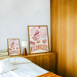 Brooklyn city art print by Caya Crum — framed in a wood-accent room