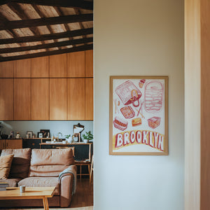 Brooklyn city art print by Caya Crum — framed in a wood-accent room