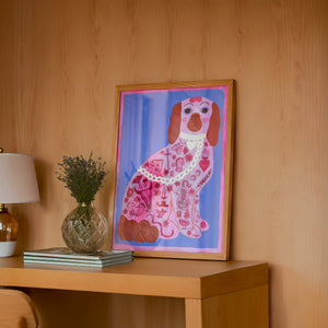 Pink Dog Tattoo dog art print by Caya Crum — framed in a wood-accent room