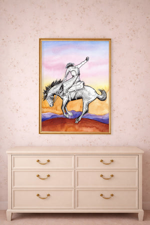Sunset bronc buster print by Caya Crum framed above a dresser
