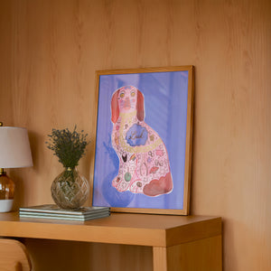 Pink Staffordshire Luck Dog maximalist dog art print by Caya Crum — framed in a wood-accent room
