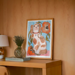 Smoking Cowboy Cavalier dog art print by Caya Crum — framed in a wood-accent room