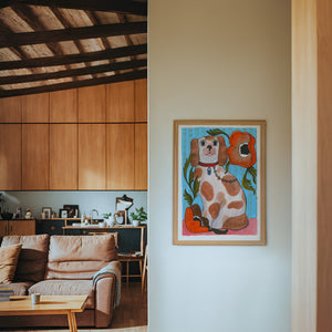 Smoking Cowboy Cavalier dog art print by Caya Crum — framed in a wood-accent room