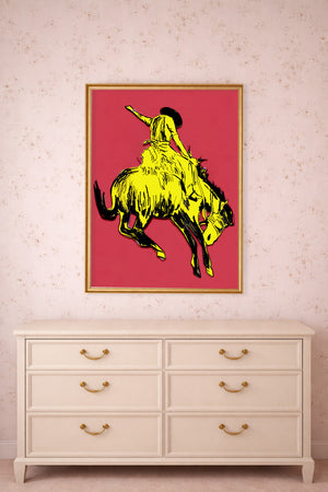 Bronc buster yellow pink print by Caya Crum framed above a dresser