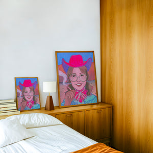 Hanna cowgirl art print by Caya Crum — framed in a wood-accent room