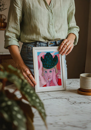 Emma cowgirl art print by Caya Crum — neutral frame room mockup