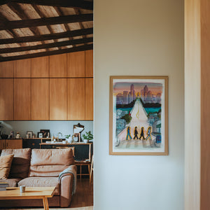 South Congress Beatles Austin print by Caya Crum — framed in a wood-accent room