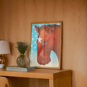 Star Horse Dreamer horse art print by Caya Crum — framed in a wood-accent room