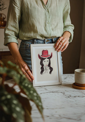 Tavi cowgirl art print by Caya Crum — neutral frame room mockup