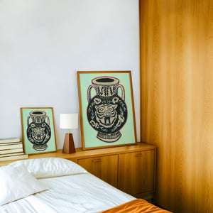 Amphora Mint Green tiger art print by Caya Crum — framed in a wood-accent room