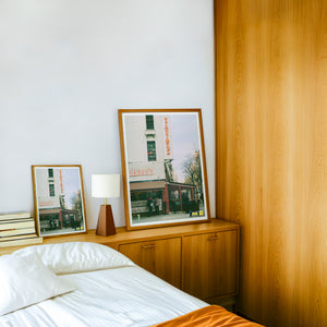 Zabar's NYC art print by Caya Crum — framed in a wood-accent room
