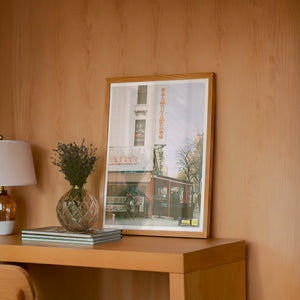 Zabar's NYC art print by Caya Crum — framed in a wood-accent room