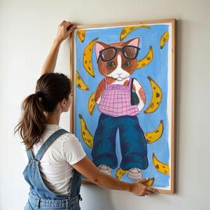 Banana Kitty cat art print by Caya Crum — framed vertical room scene