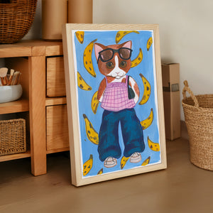 Banana Kitty cat art print by Caya Crum — framed vertical room scene