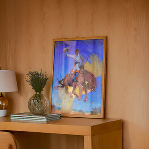 Bronco Buster Night rodeo art print by Caya Crum — framed in a wood-accent room