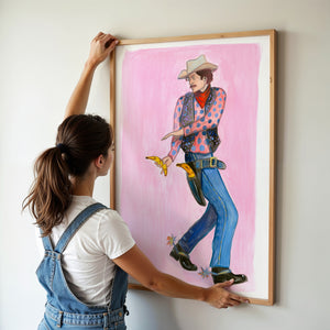 Banana Guns cowboy art print by Caya Crum — framed vertical room scene
