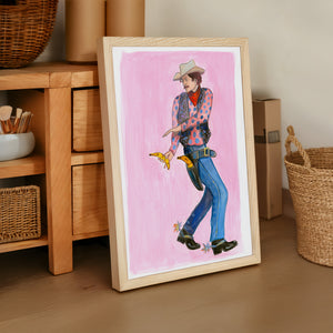 Banana Guns cowboy art print by Caya Crum — framed vertical room scene