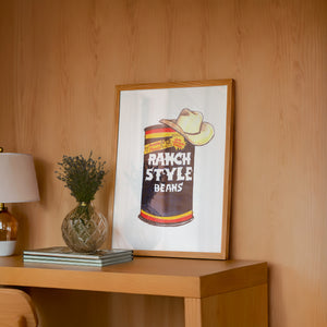 Ranch Style Beans Sketchbook kitchen art print by Caya Crum — framed in a wood-accent room