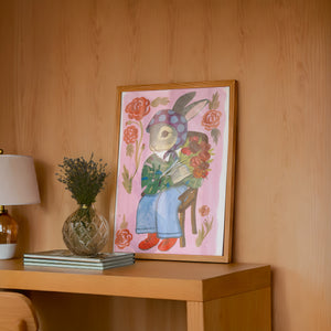 Bunny with Flowers bunny art print by Caya Crum — framed in a wood-accent room