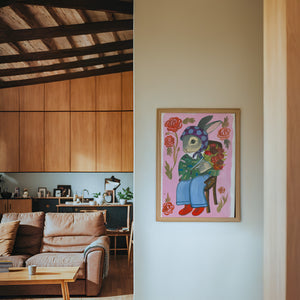 Bunny with Flowers bunny art print by Caya Crum — framed in a wood-accent room