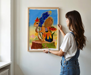 Ms. Squirrel in the Bluebonnets squirrel art print by Caya Crum — framed vertical room scene