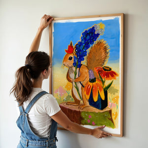 Ms. Squirrel in the Bluebonnets squirrel art print by Caya Crum — framed vertical room scene