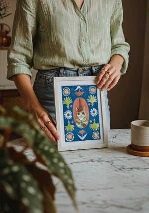 Party Cat Poppett cat art print by Caya Crum — neutral frame room mockup