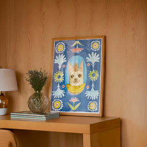 Chip the Party Dog Poppett dog art print by Caya Crum — framed in a wood-accent room