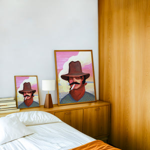 Smoking Cowboy cowboy art print by Caya Crum — framed in a wood-accent room
