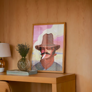 Smoking Cowboy cowboy art print by Caya Crum — framed in a wood-accent room