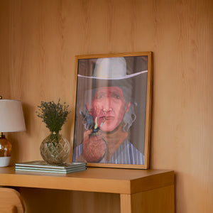 Jimmy James cowboy art print by Caya Crum — framed in a wood-accent room