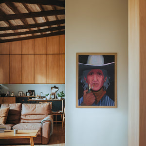 Jimmy James cowboy art print by Caya Crum — framed in a wood-accent room