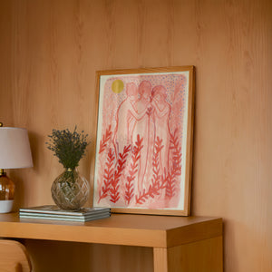 Greco Roman Dancing Maidens pink wall art print by Caya Crum — framed in a wood-accent room
