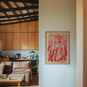 Greco Roman Dancing Maidens pink wall art print by Caya Crum — framed in a wood-accent room