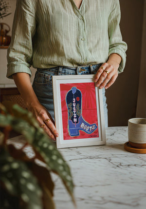 Justin Boot cowboy boot art print by Caya Crum — neutral frame room mockup