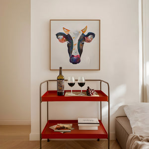 Watercolor cow portrait print by Caya Crum framed in a styled room