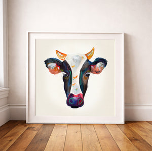 Watercolor cow portrait print by Caya Crum framed in a modern room