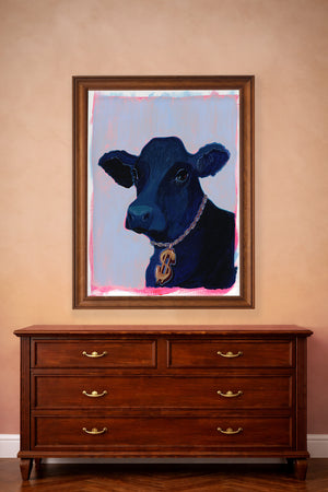 Western Wall decor or a black cow in a pop art style wearing a gold necklace with dollar sign.  This art print is titled, "Money Cow" and as a framed 24x36" sits above a bedroom dresser 