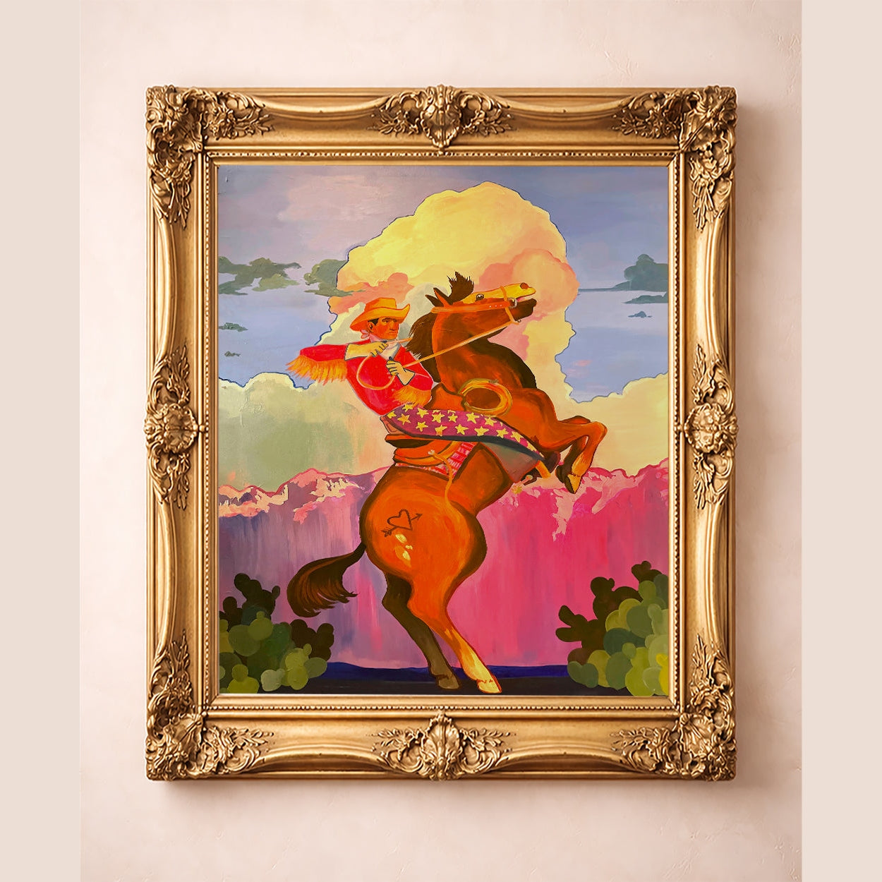 Cowboy Carl Rodeos Into the Sunset Print shown in a gold frame, cowboy on a rearing horse in a western landscape