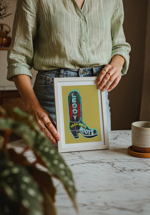 Leddy Boot Ochre cowboy boot art print by Betsy Crum — neutral frame room mockup