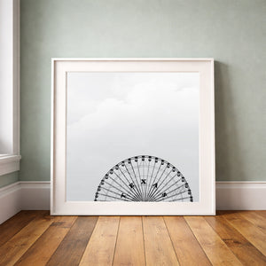 Texas Star Ferris Wheel print by Betsy Crum framed upright against a grey-green wall
