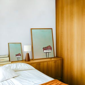 Earl Abel's marquee San Antonio art print by Betsy Crum — framed in a wood-accent room