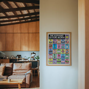 Alphabet Nursery Decor Fort Worth art print by Betsy Crum — framed in a wood-accent room