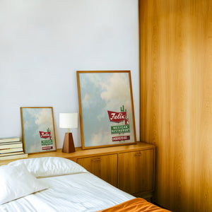 Felix Restaurant Houston art print by Betsy Crum — framed in a wood-accent room