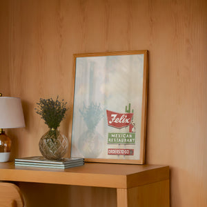Felix Restaurant Houston art print by Betsy Crum — framed in a wood-accent room