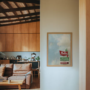 Felix Restaurant Houston art print by Betsy Crum — framed in a wood-accent room