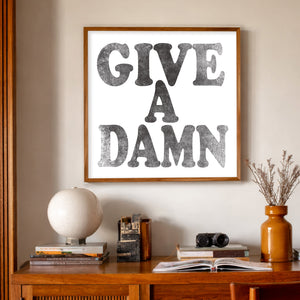 Give a Damn punk typography print by Betsy Crum framed above midcentury furniture